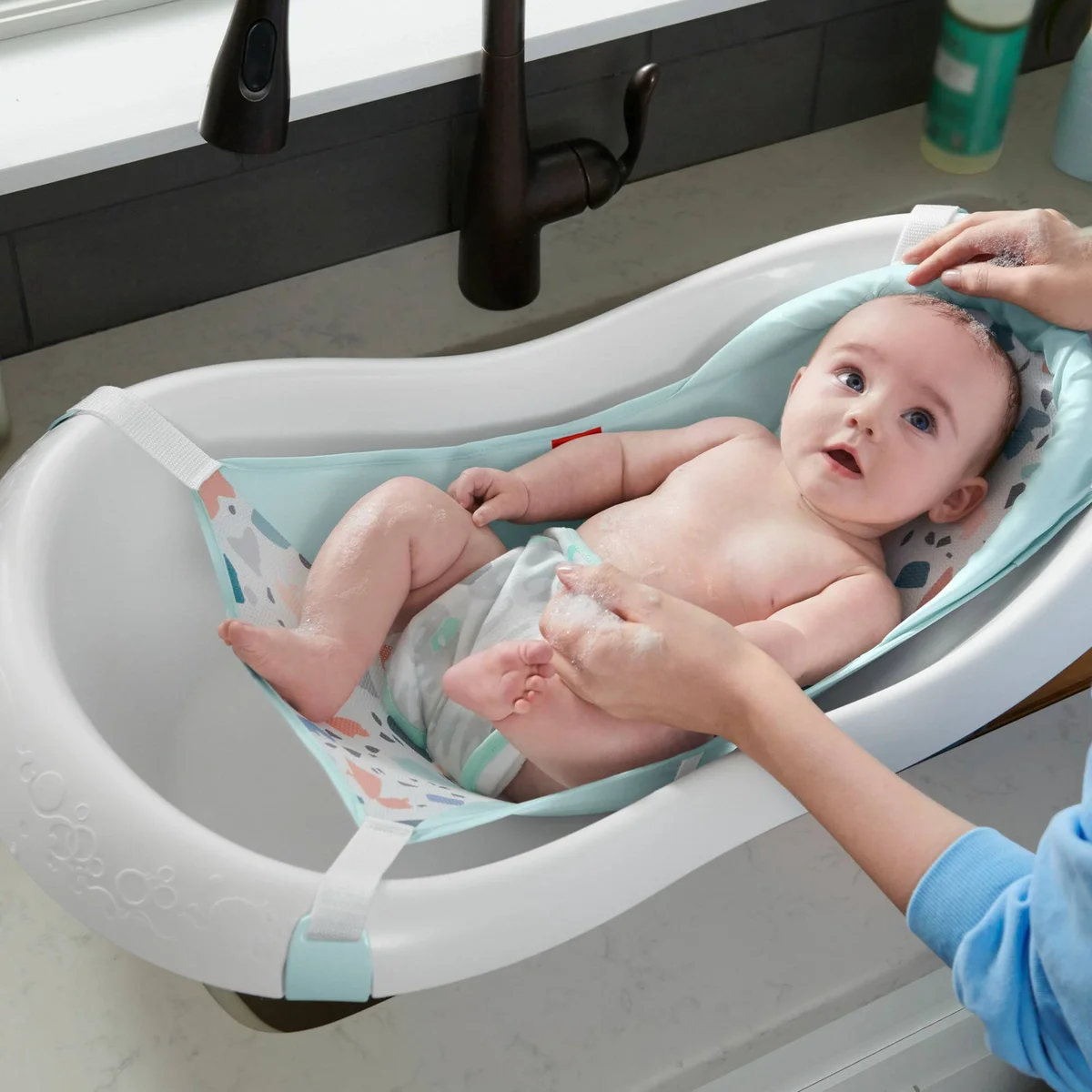 Fisher-Price 4-in-1 Sling 'n Seat Tub in use with a newborn in the mint mesh sling