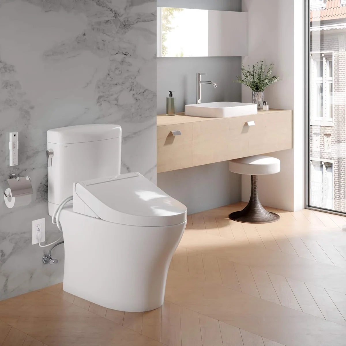 TOTO Washlet C5 installed on toilet in a modern marble and wood bathroom