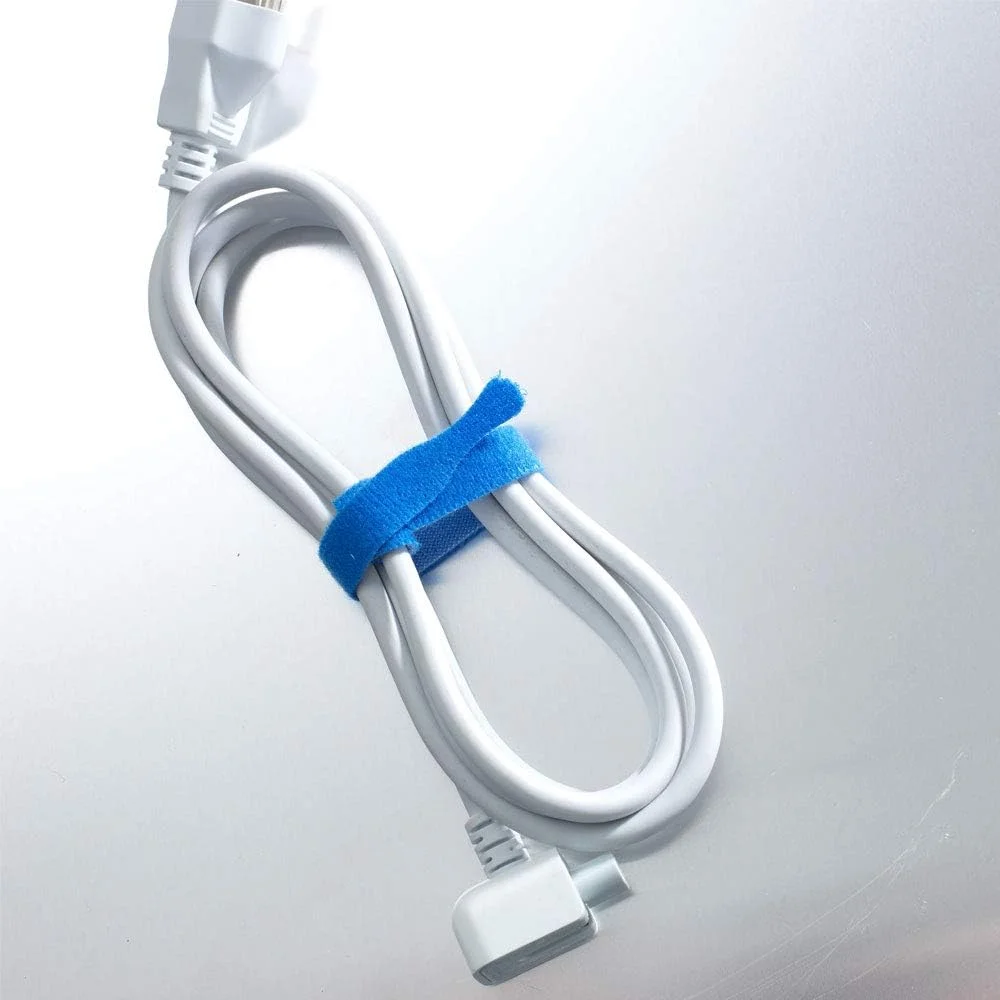 Blue VELCRO Brand ONE-WRAP thin tie wrapping a coiled white power cable