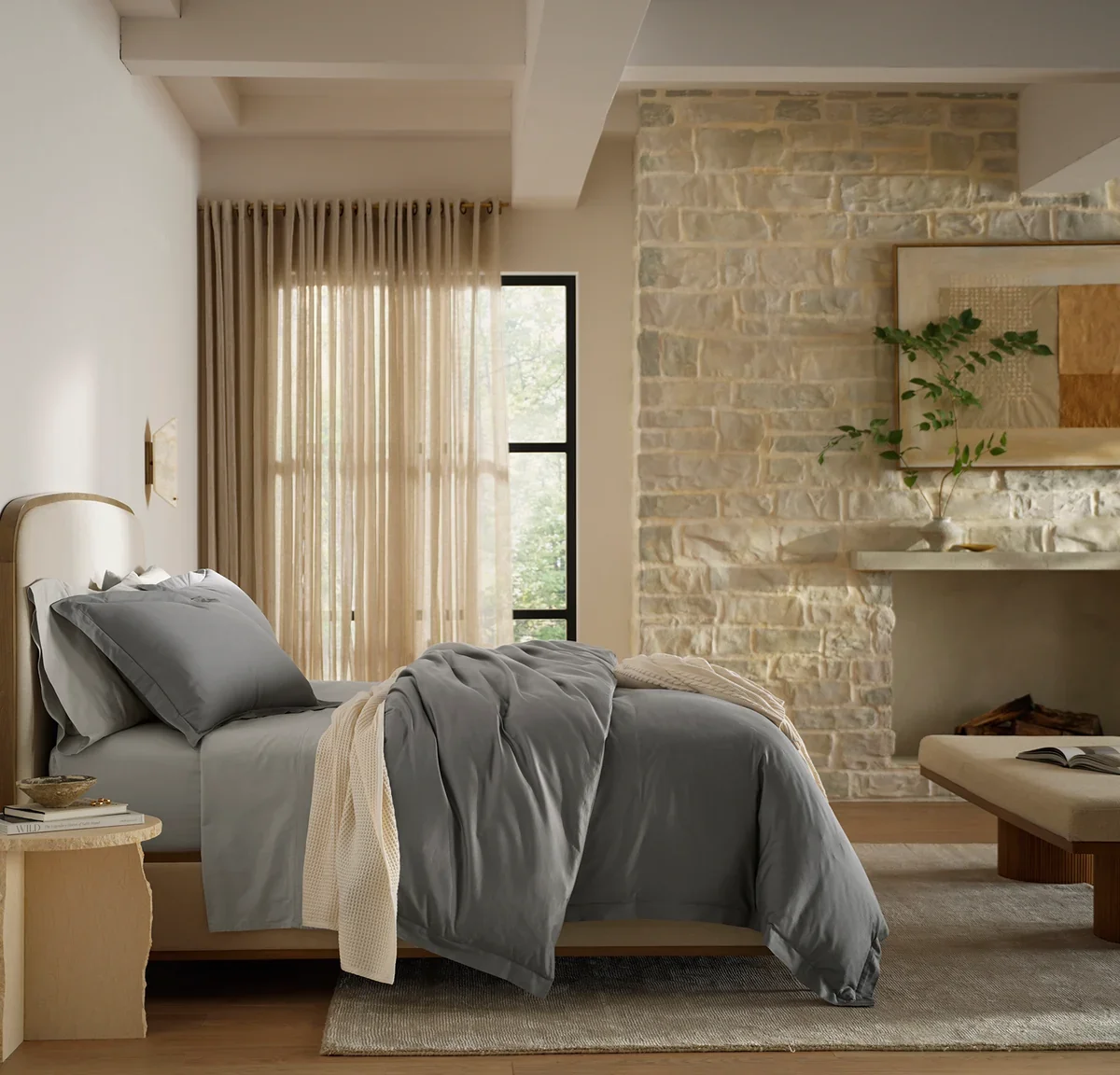Boll & Branch Signature Hemmed Duvet Set in Stone styled on a made bed in a neutral bedroom