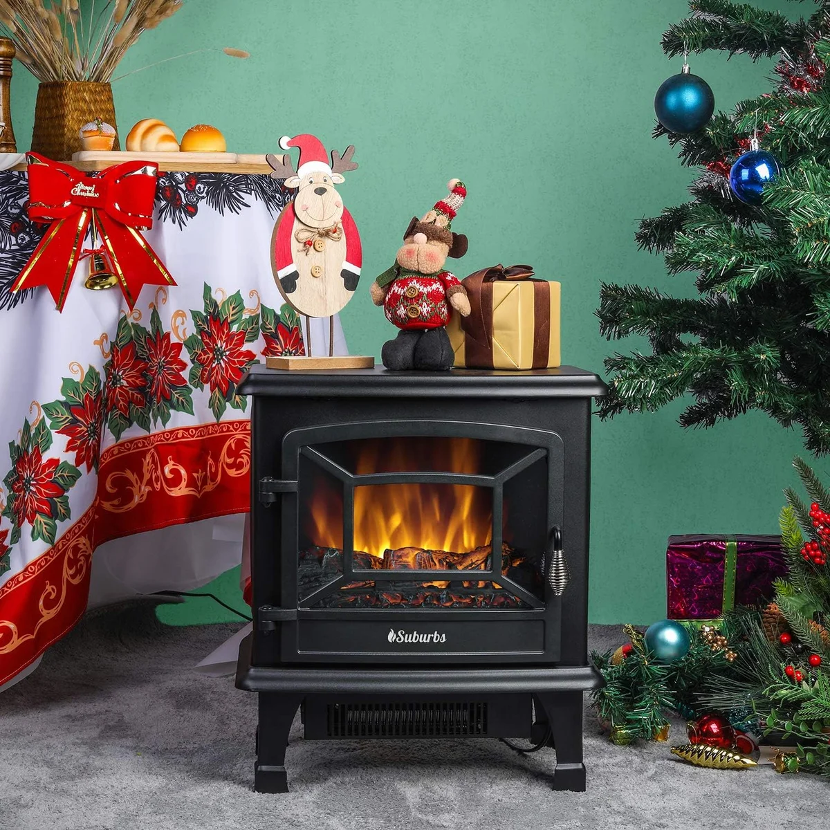 TURBRO Suburbs TS20 electric fireplace stove in a festive holiday room setting beside a Christmas tree, front view with realistic flames lit