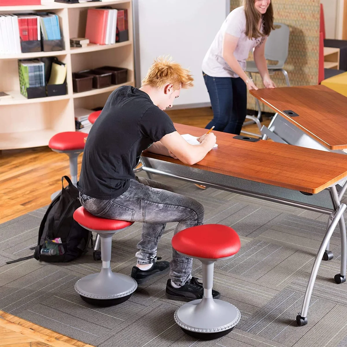 Student using Learniture Active Learning Stool at classroom desk