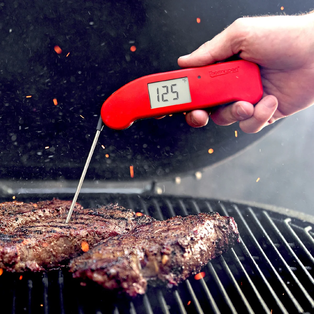 Orange ThermoWorks Thermapen ONE probing a pecan pie in the oven, reading 177 degrees F