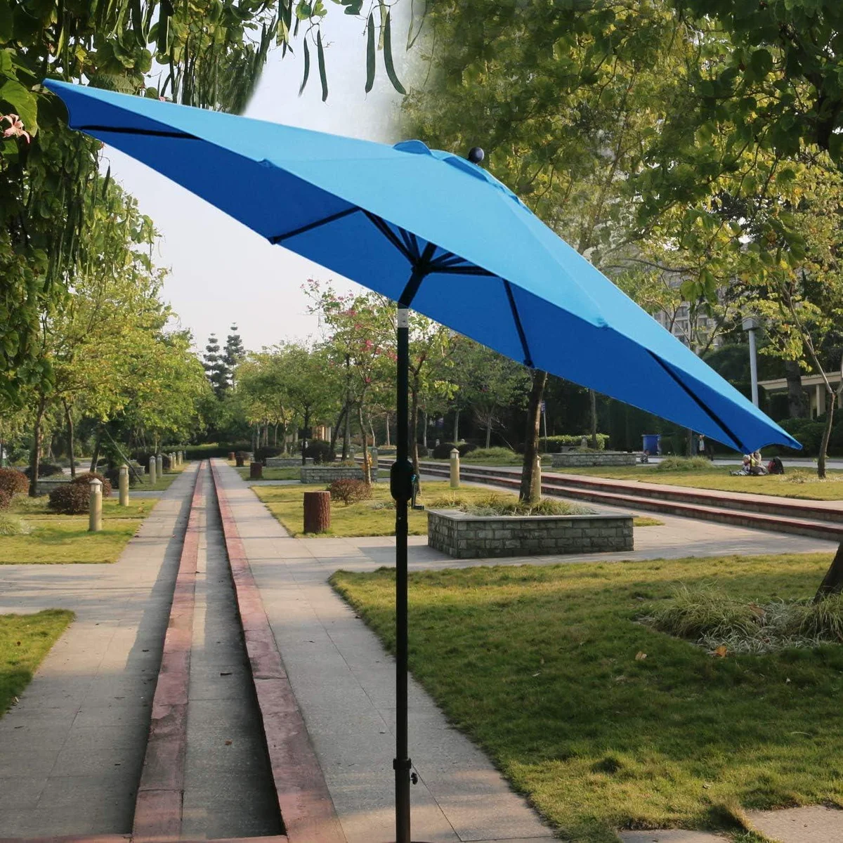 Sunnyglade 9' Patio Umbrella in use outdoors in a park setting