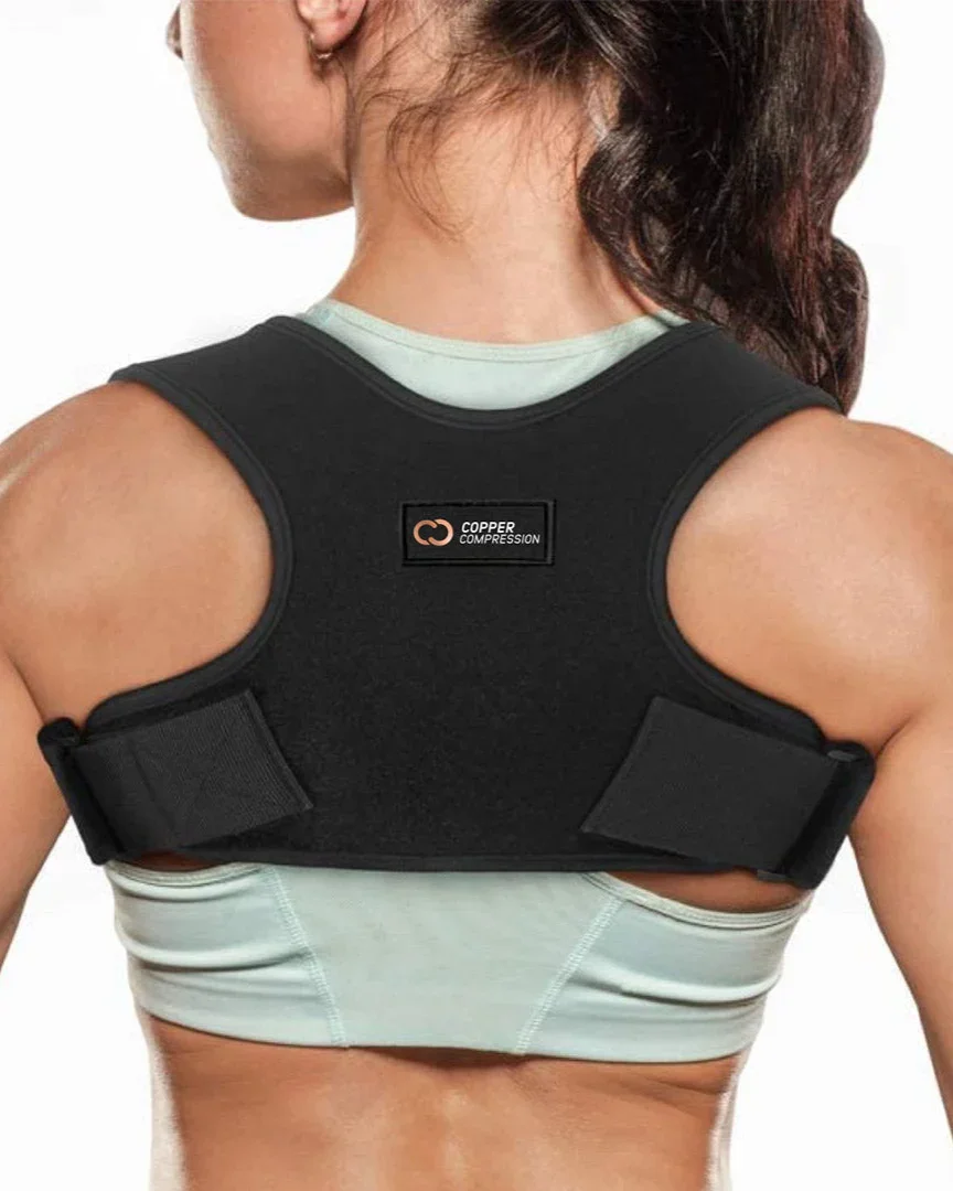 Copper Compression Posture Corrector worn over athletic wear, rear view showing the low-profile fit