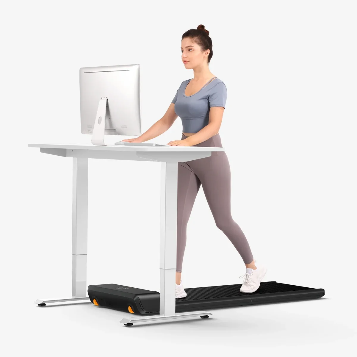 WalkingPad A1 Pro in use under a standing desk with person working at a monitor