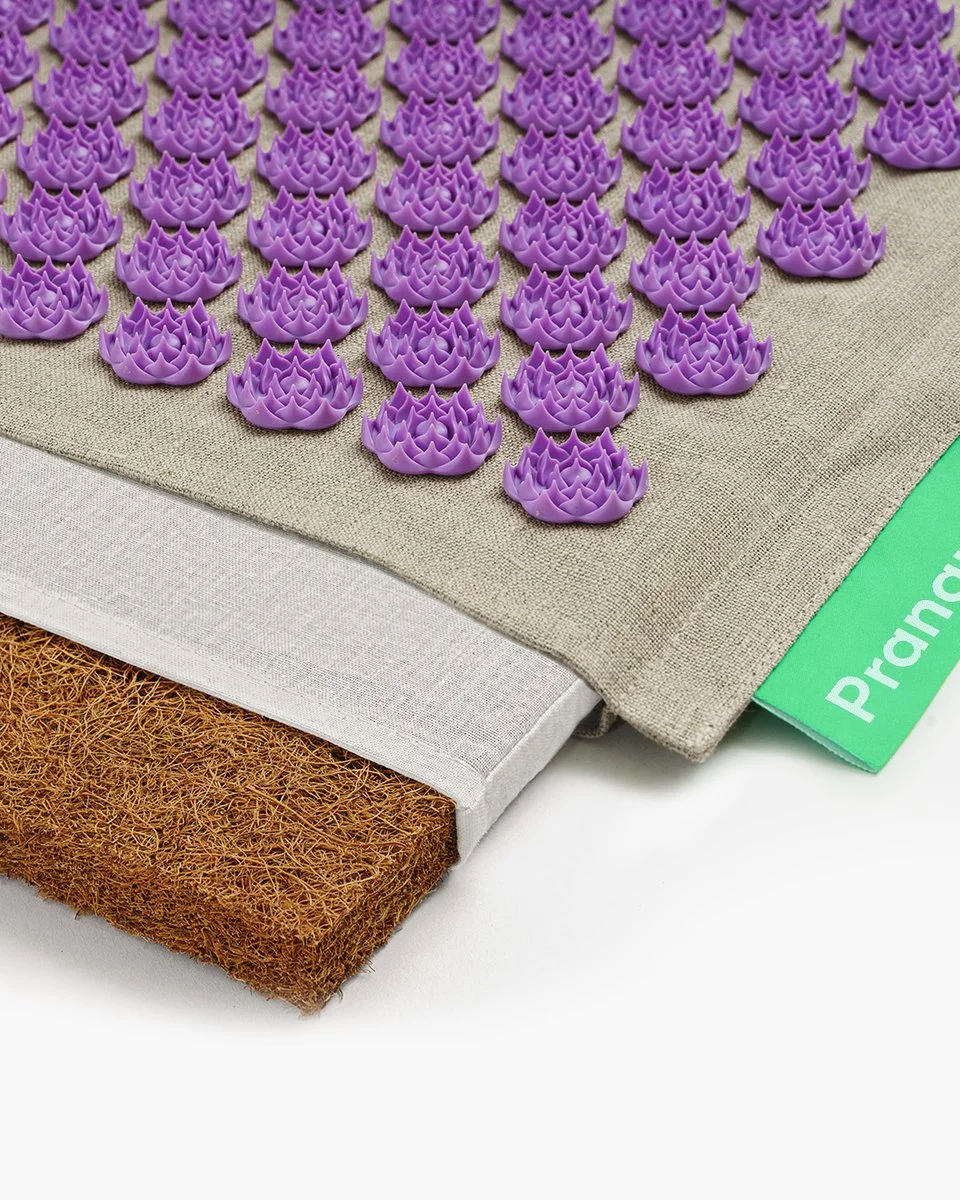 Close-up of the Pranamat ECO natural linen cover, lotus-disc spikes, and coconut-fiber padding