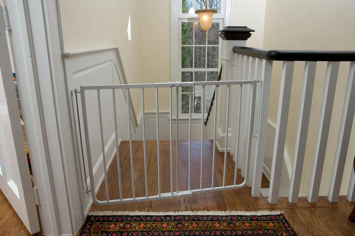 Cardinal Gates SS-30 white gate installed at top of stairway with banister