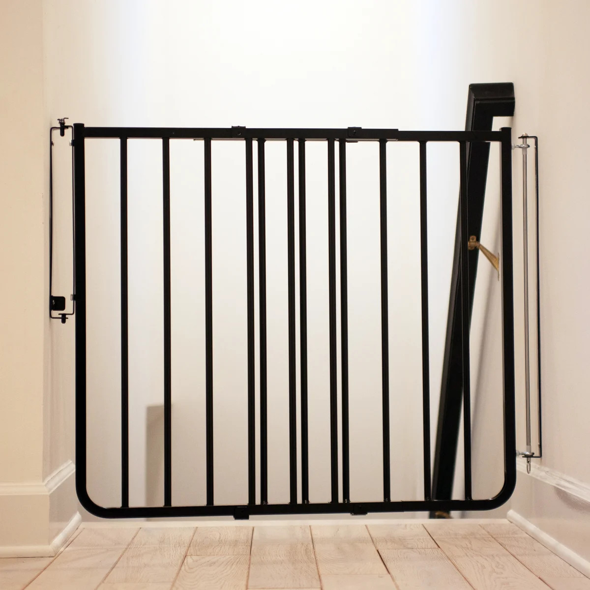 Cardinal Gates SS-30 Stairway Special black aluminum gate installed in corner setting