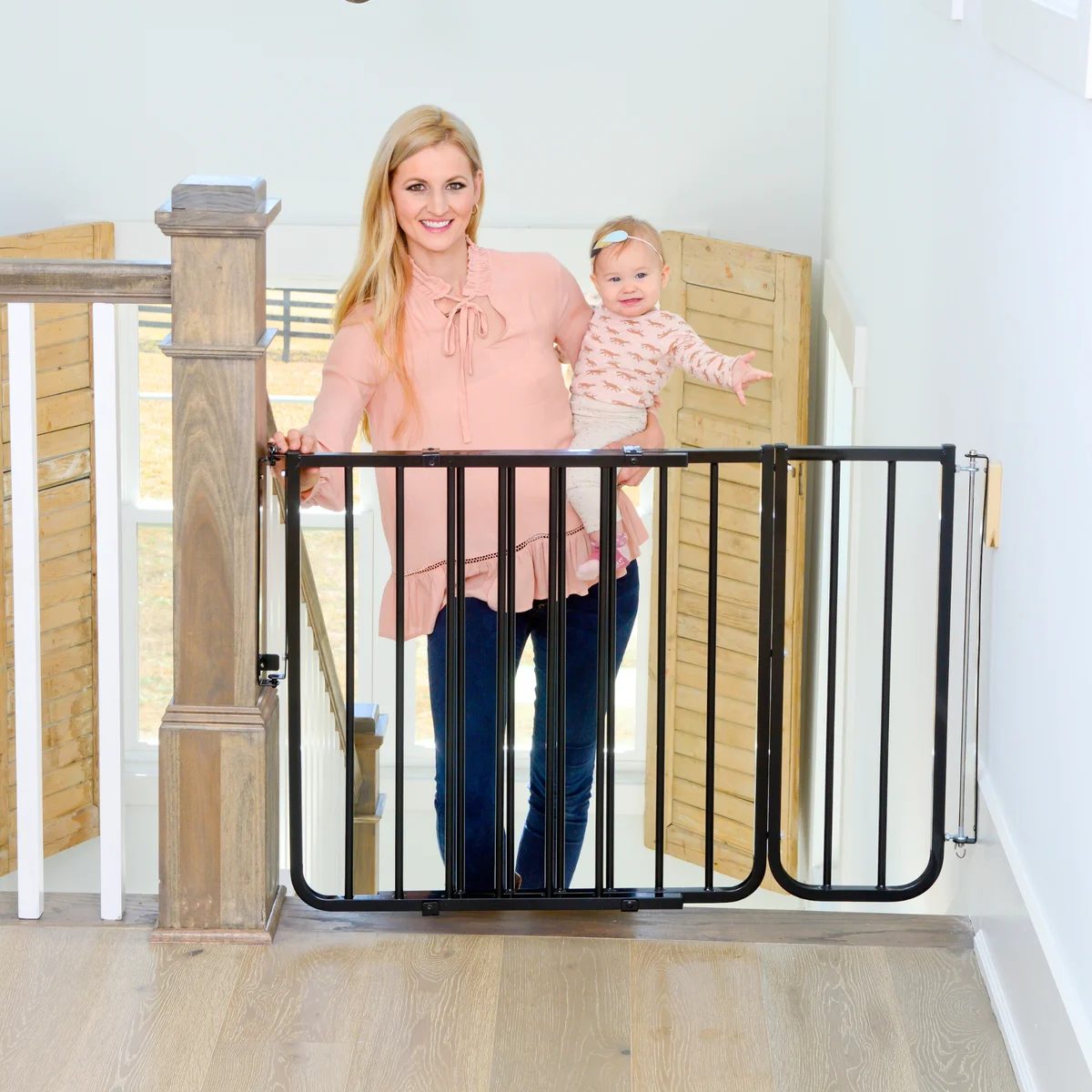 Cardinal Gates SS-30 black gate installed at top of stairs with parent and baby