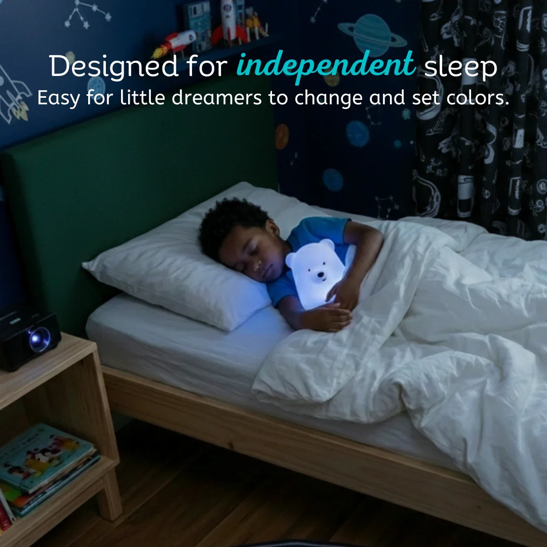 Child holding glowing LumiPets Bear Night Light in a dark bedroom