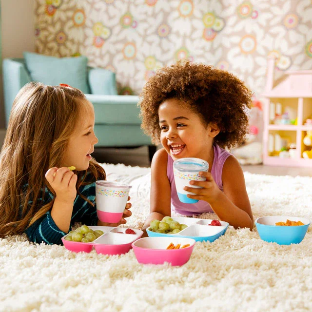 Two children using Munchkin Splash plates and cups on floor