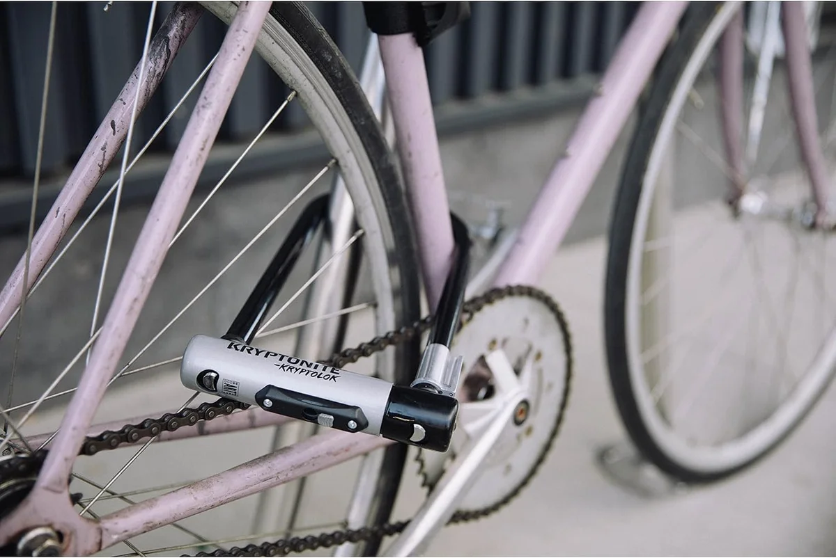 Kryptonite KryptoLok Standard U-lock mounted on a pink bicycle frame in use