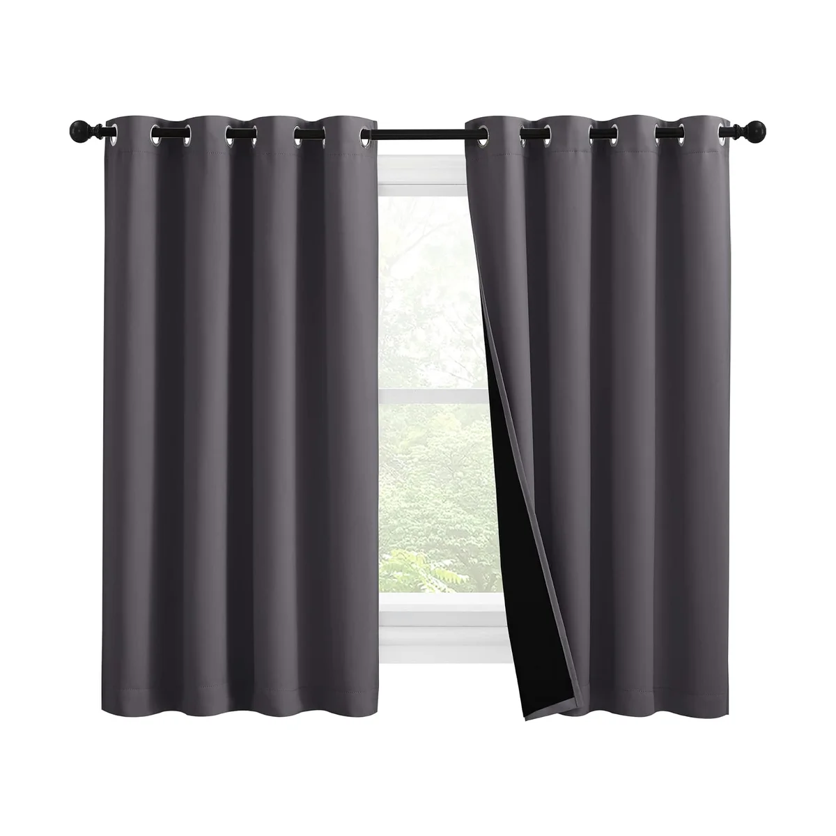 NICETOWN grey 100% blackout grommet-top curtains hung over a window with one panel folded back to reveal the black thermal lining