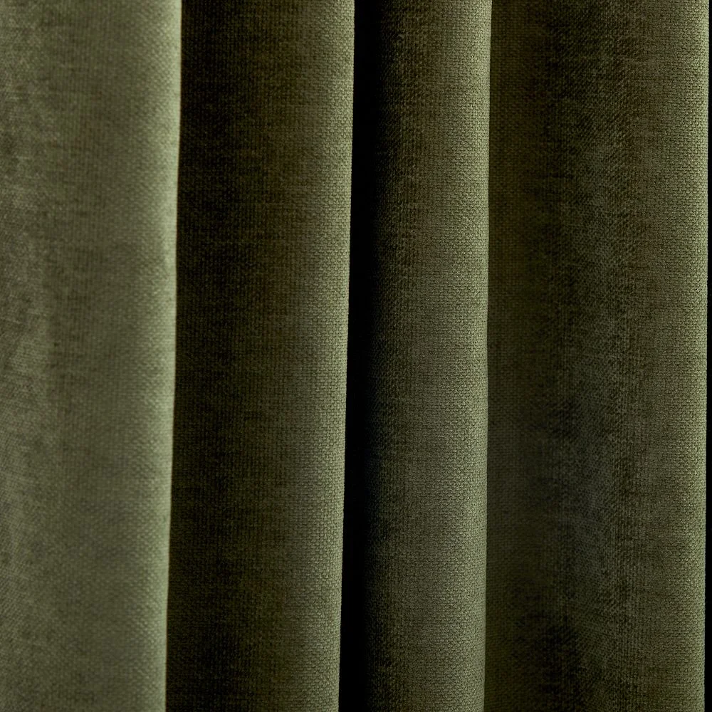 Close-up of the West Elm Worn Velvet Blackout Curtain fabric in olive showing the plush velvet texture