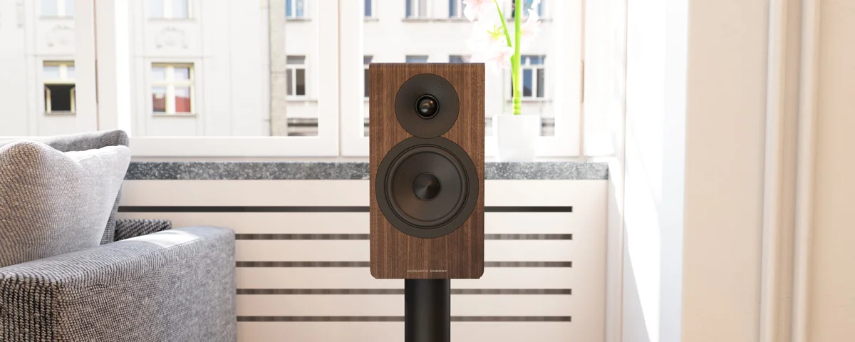 Acoustic Energy AE300 Mk2 walnut finish on speaker stand in living room, no grille