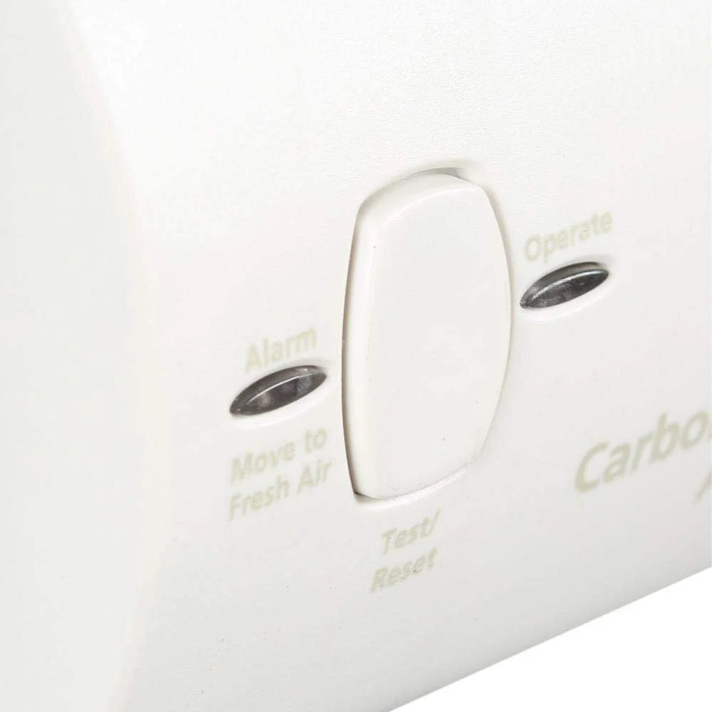 Kidde KN-COB-B-LPM carbon monoxide alarm close-up of the Test/Reset button with Alarm and Operate status LEDs