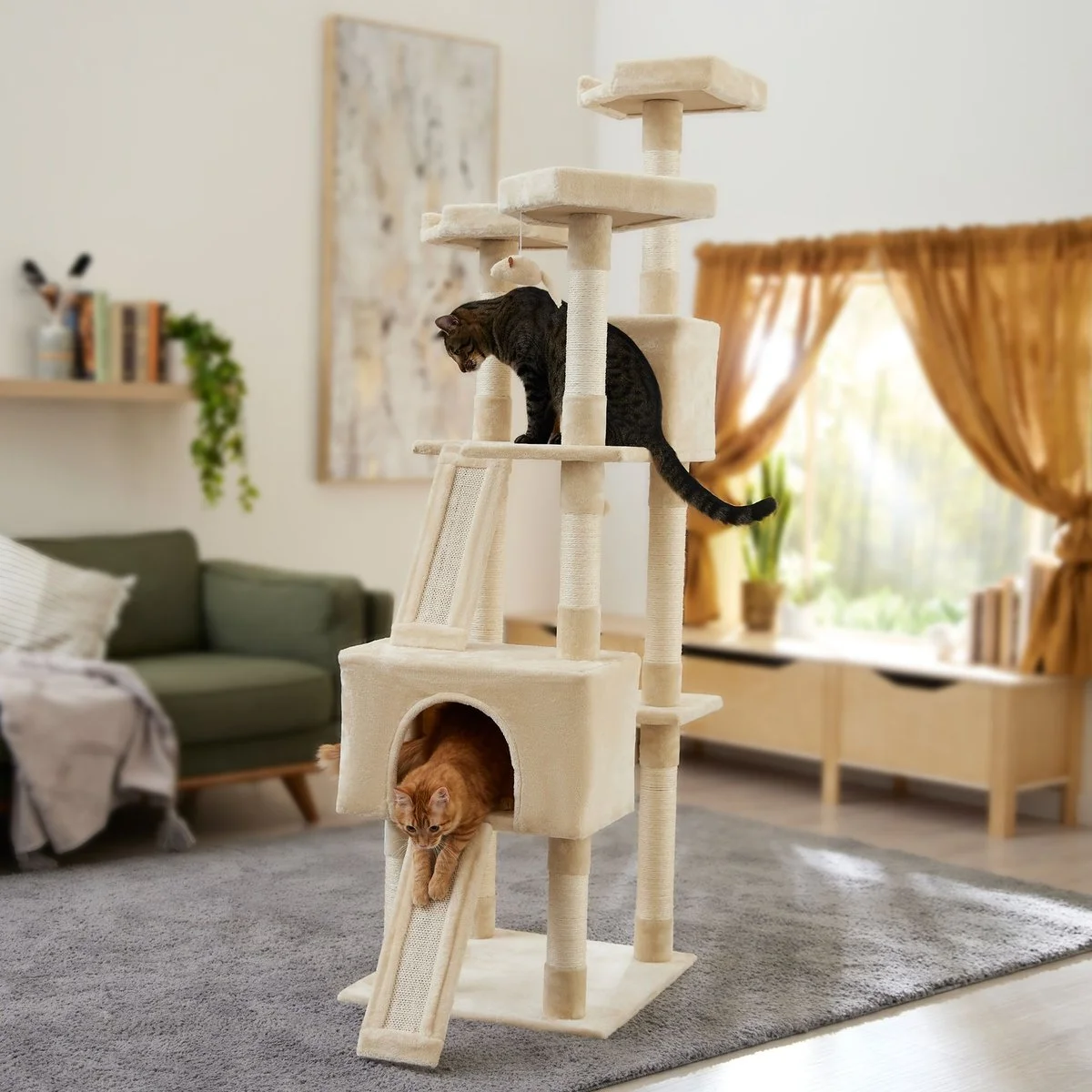 Frisco 72-in Faux Fur Cat Tree & Condo in cream shown in a living room with two cats climbing its condos, ramps, and sisal posts
