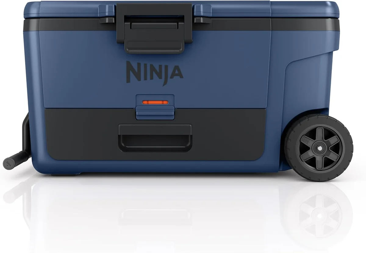 Ninja FrostVault 65Q lower-angle front view highlighting the Dry Zone drawer panel handle and never-flat wheels