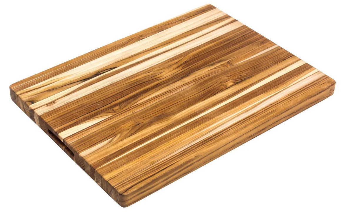 Teakhaus Extra-Large Professional Cutting Board shown at an angle on a white background, showing the edge-grain teak strips and rounded corners