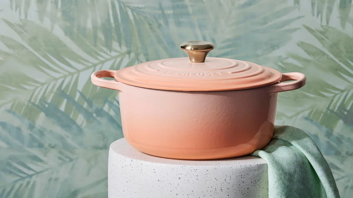 Le Creuset Signature Round Dutch Oven in Peche styled on a pedestal with a linen napkin
