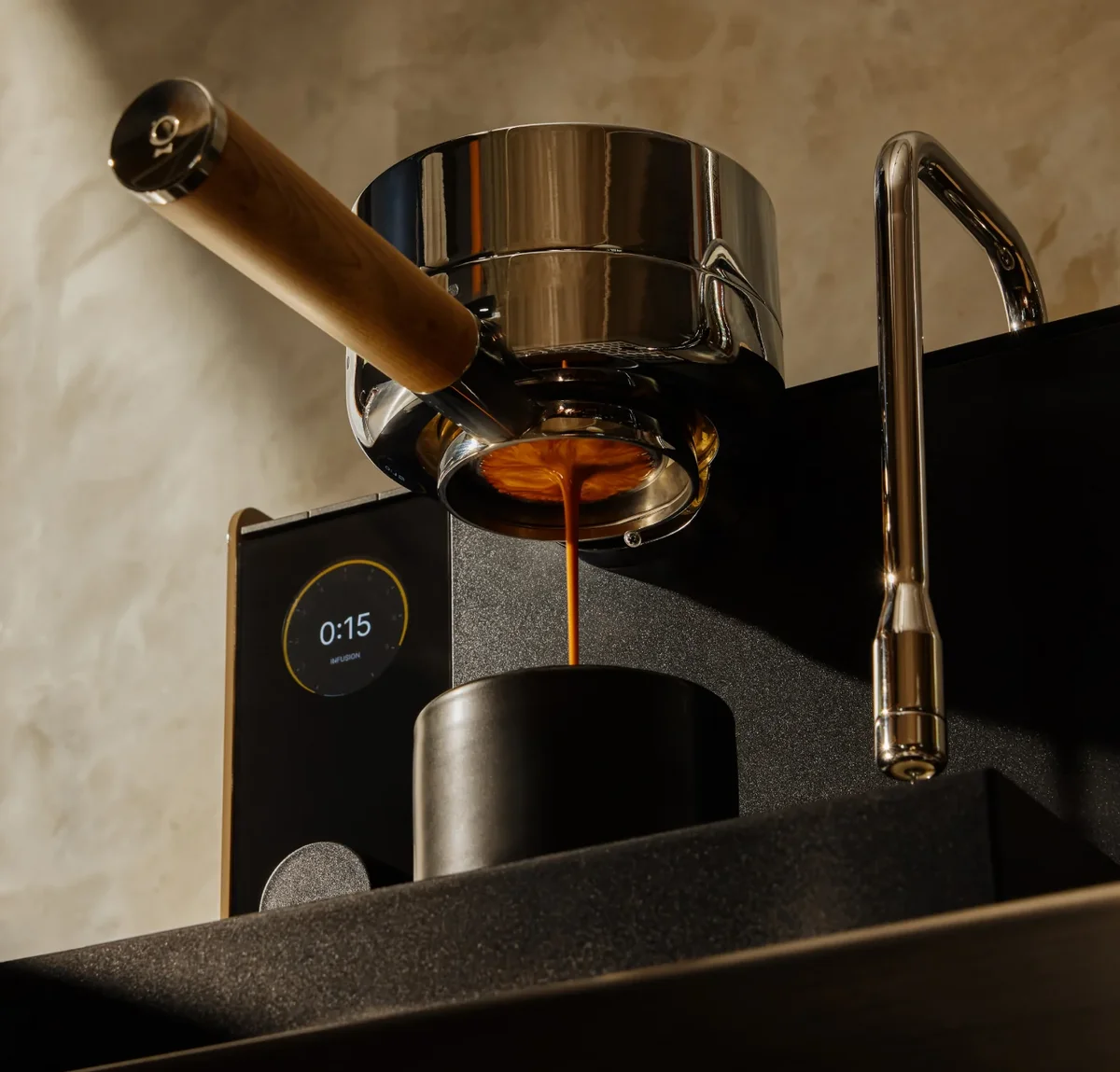 Fellow Espresso Series 1 pulling a shot, close-up of espresso flowing from the walnut-handled portafilter with the infusion timer on screen