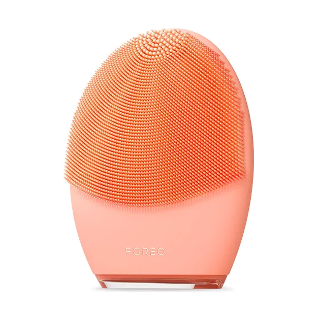 FOREO LUNA 4 facial cleansing device in peach coral front view