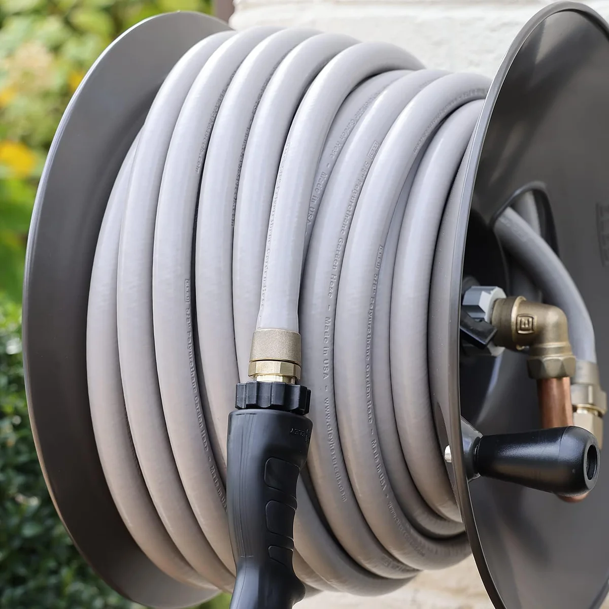 Eley Polyurethane Garden Hose wound on a metal hose reel mounted outdoors