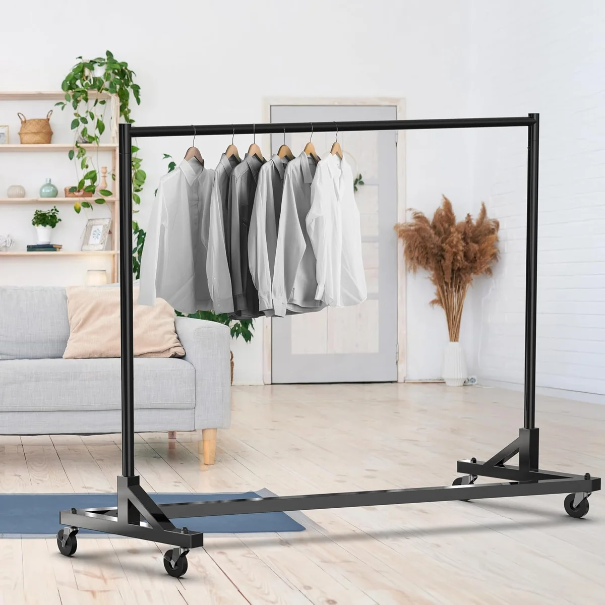 Simple Houseware black Z-Base Garment Rack seen from the opposite side in a living room, showing the reversed Z base and corner gussets