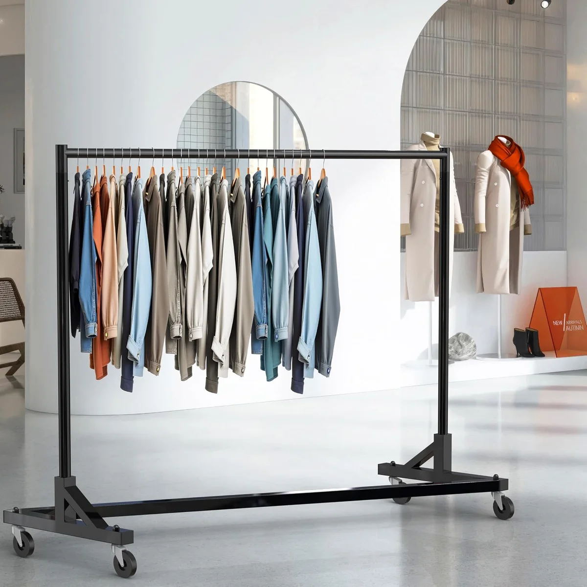Simple Houseware black Z-Base Garment Rack fully loaded with shirts and jackets in a retail boutique, rolling on four casters