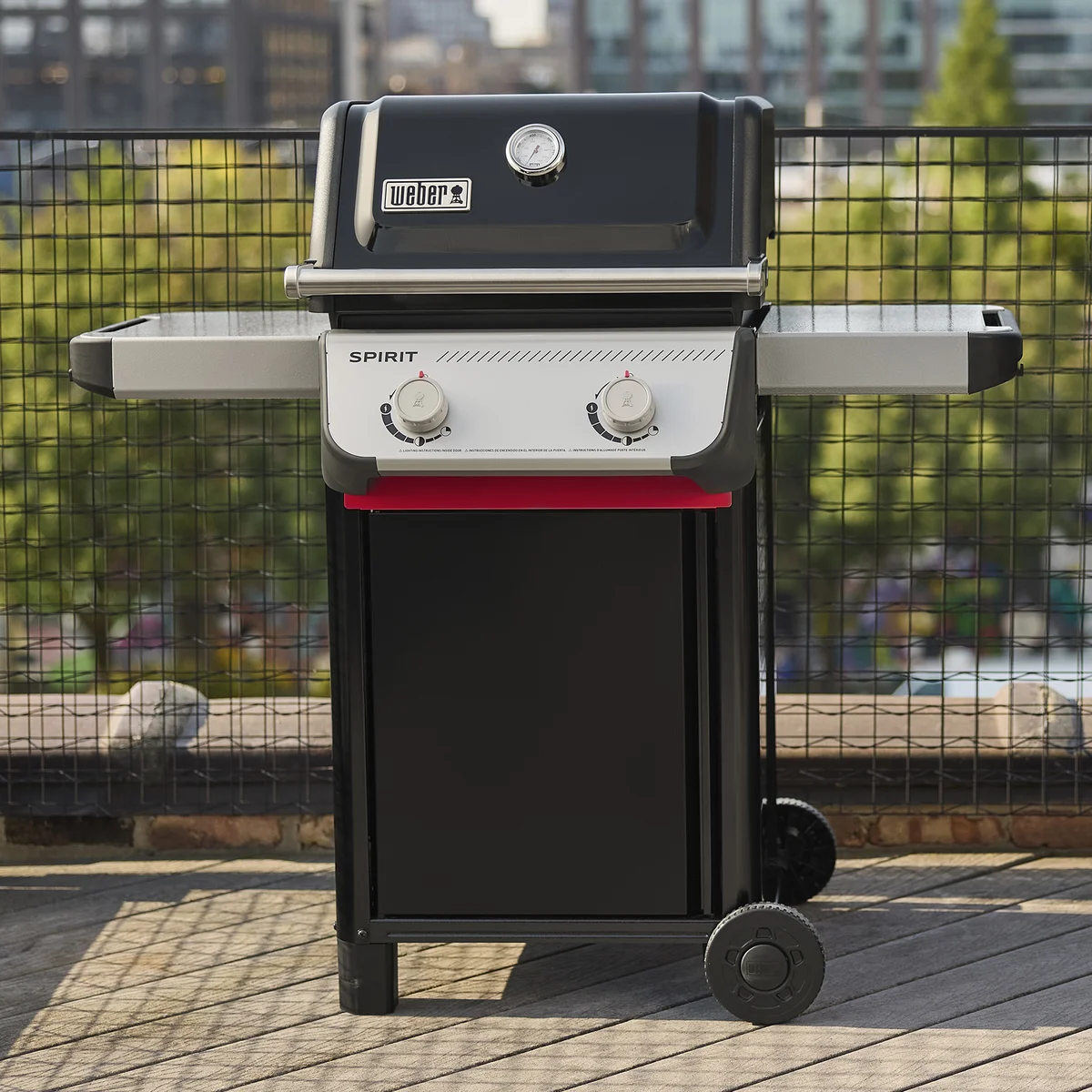 Weber Spirit E-210 gas grill in a rooftop outdoor setting