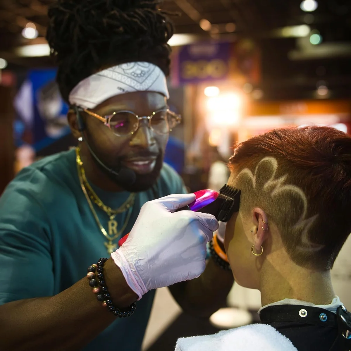 Barber using Stylecraft Rebel clipper to cut intricate hair design on client