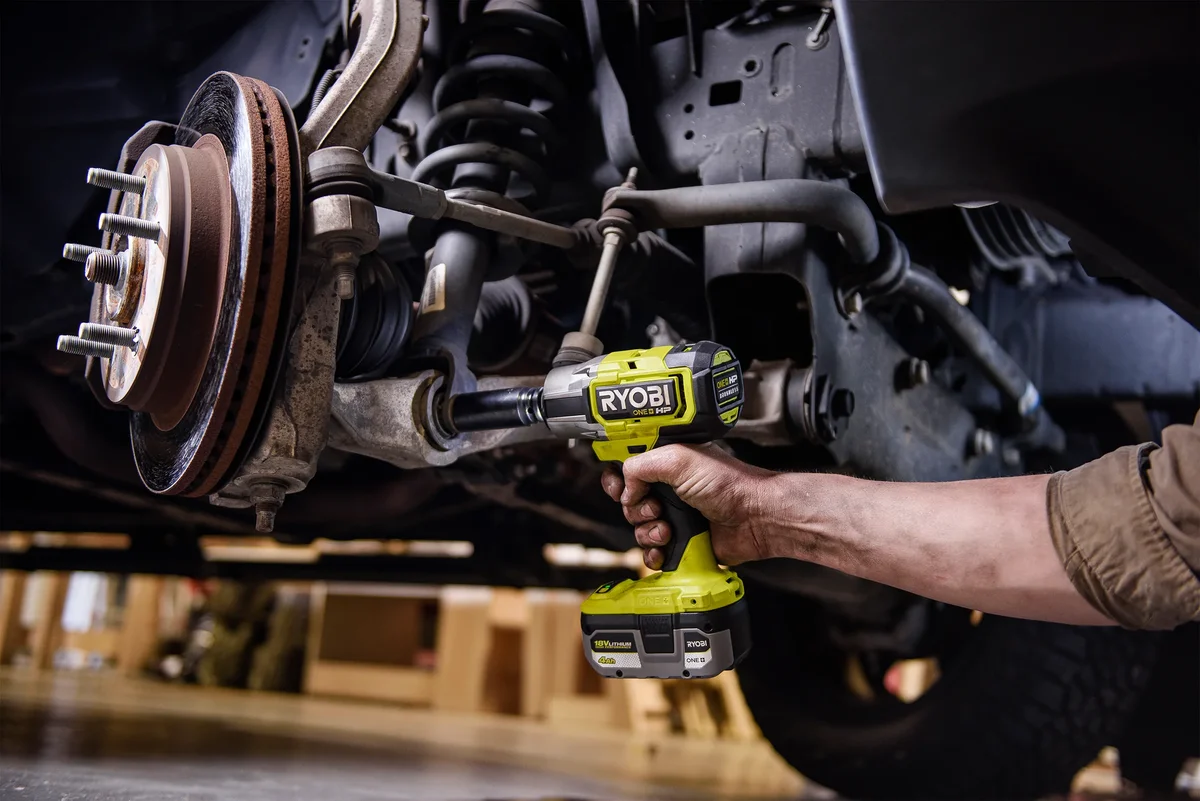 Ryobi P262 Impact Wrench working on suspension components under a vehicle