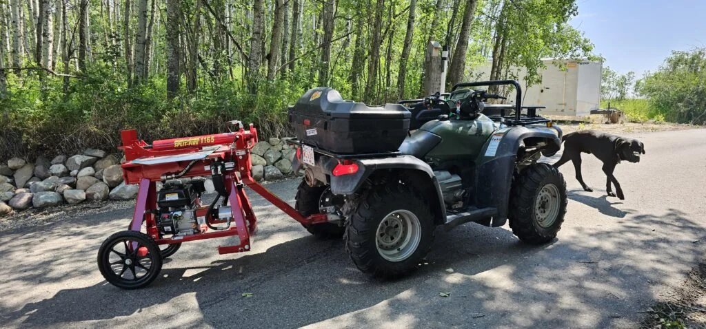 Split-Fire 2265 being towed behind an ATV on a woodland trail