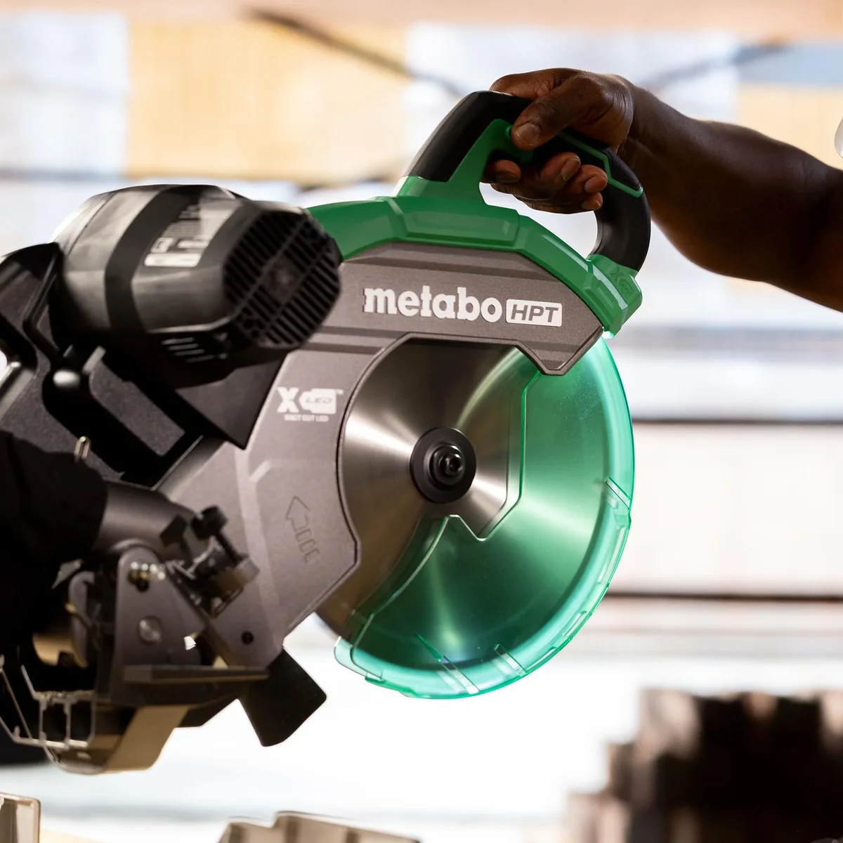 Metabo HPT C12RSH3 blade guard and motor head close-up, lifestyle workshop setting