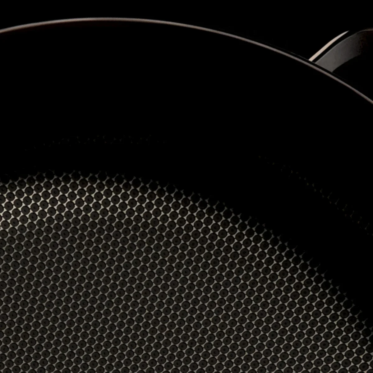 Close-up of the Our Place Titanium Always Pan Pro's dimpled titanium cooking surface texture