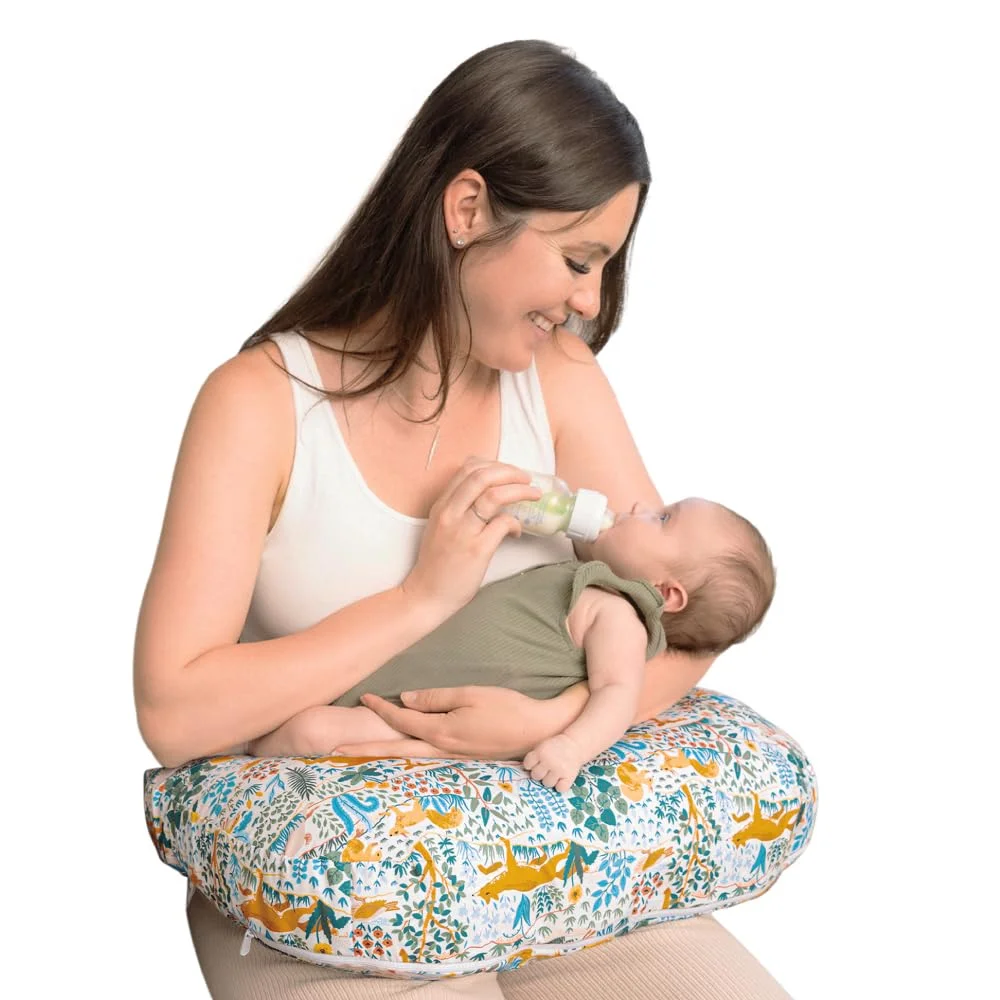 Mother bottle feeding baby with Boppy Original Nursing Pillow, colorful jungle animals cover