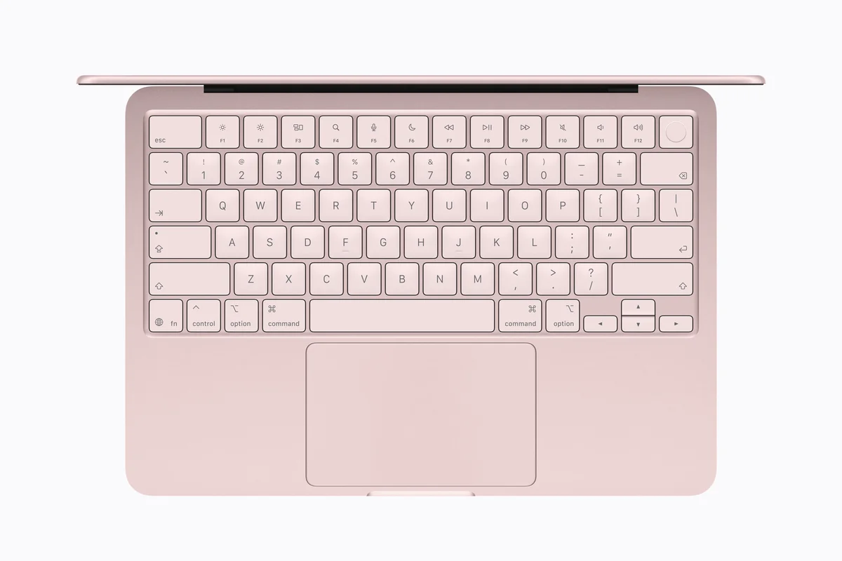 Apple MacBook Neo in Blush, top-down view of the full-size keyboard and large trackpad