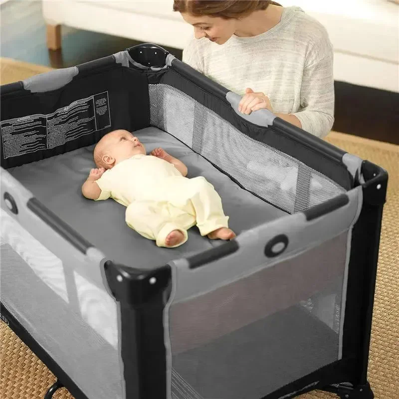 Graco Pack 'n Play bassinet mode with newborn baby and mother nearby