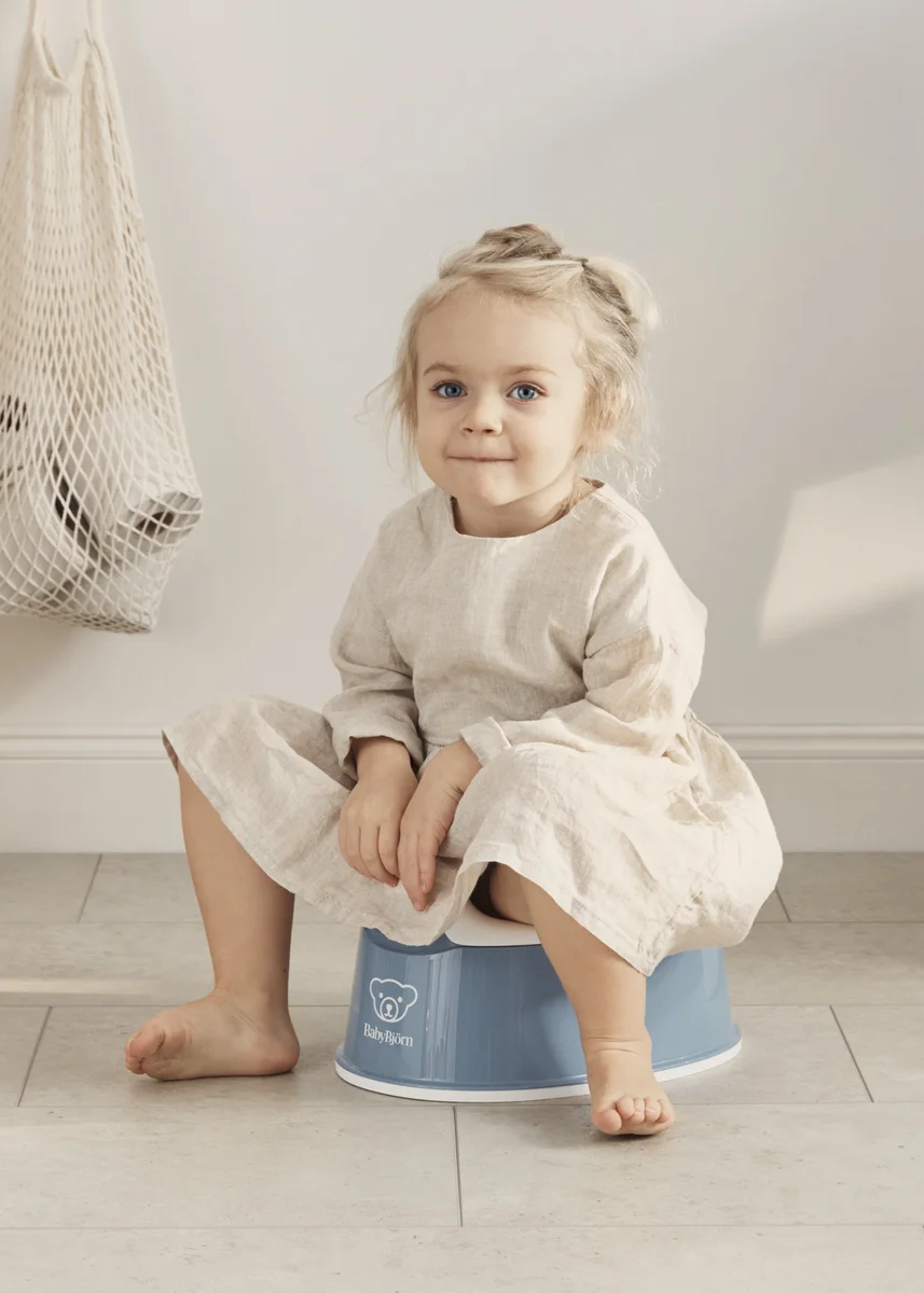 Toddler sitting on BabyBjorn Smart Potty in use, lifestyle shot