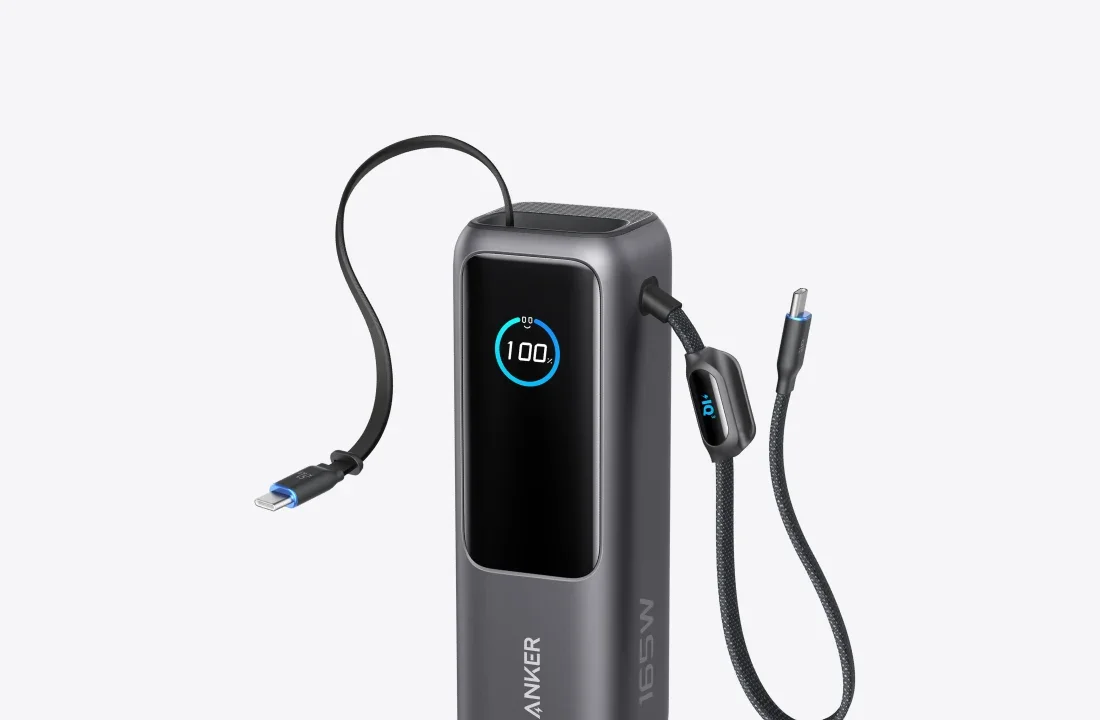 Anker Laptop Power Bank 165W with both built-in USB-C cables extended: the retractable flat cable from the top and the braided strap cable from the side
