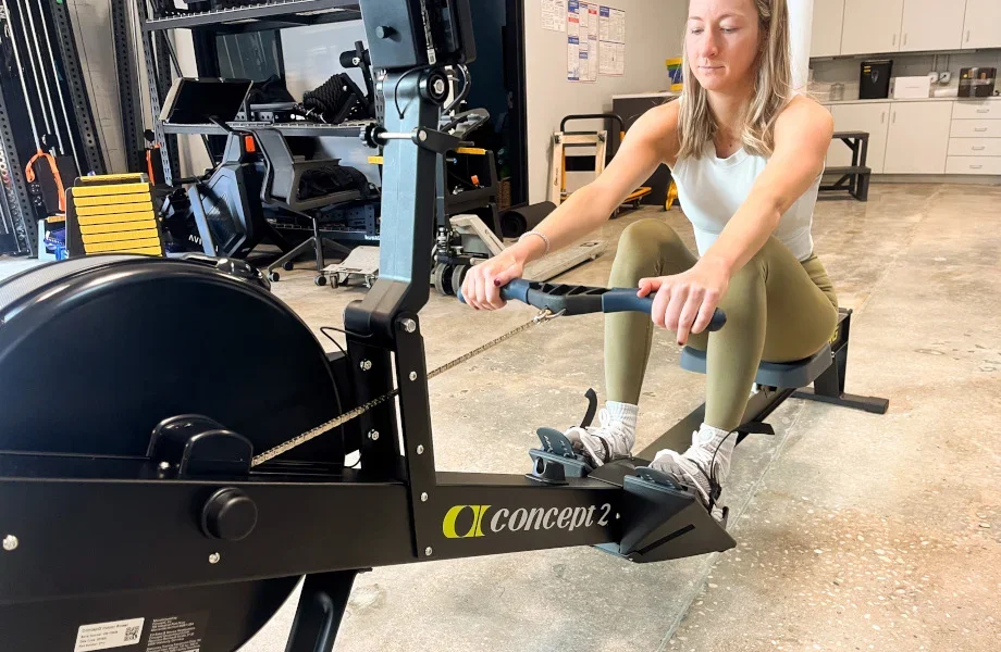 Concept2 RowErg — athlete in drive position showing seat and footrest detail