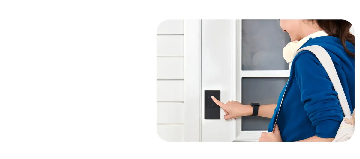 Close-up of a finger entering a code on the Aqara U50 touchscreen keypad mounted on a white door