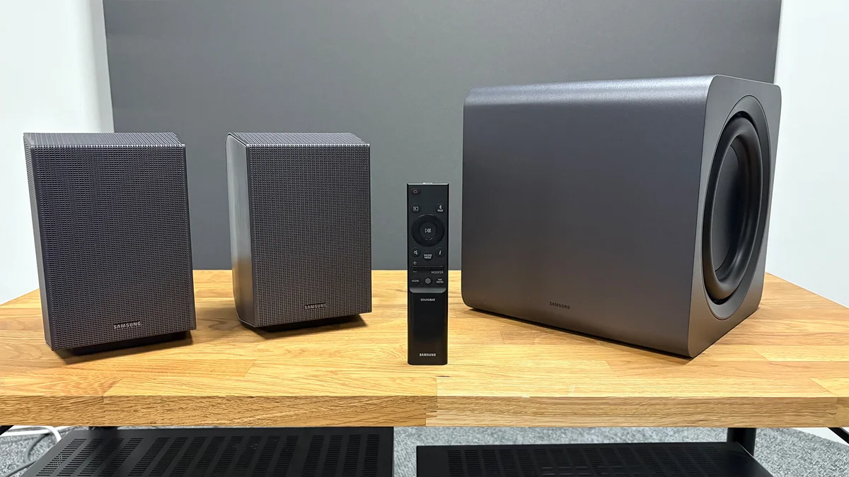 Samsung HW-Q990F rear speakers, cube subwoofer, and remote controller close-up