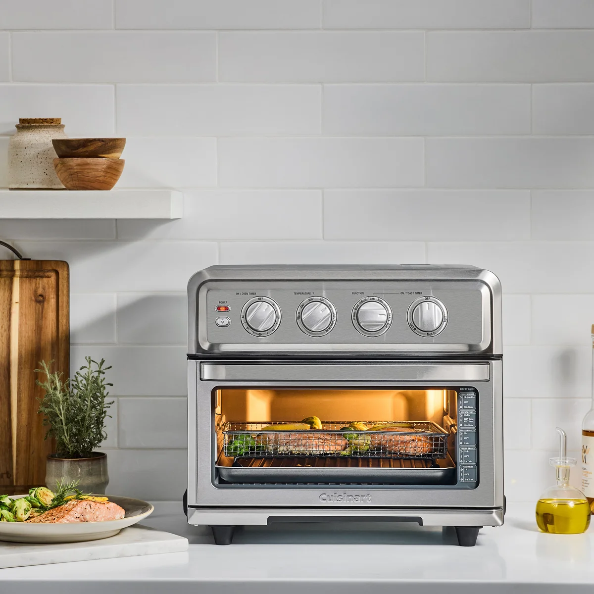 Cuisinart TOA-70 in kitchen lifestyle setting with salmon and vegetables air frying inside