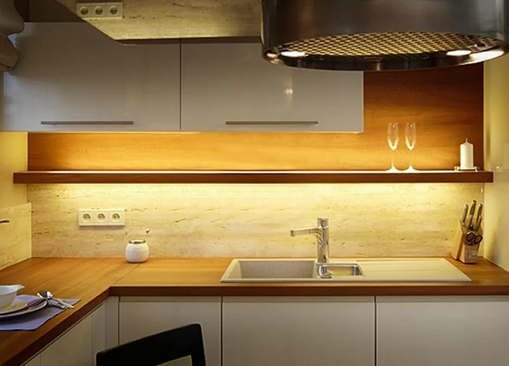 Wobane warm white LED strip lighting a backsplash and floating shelf above a kitchen sink