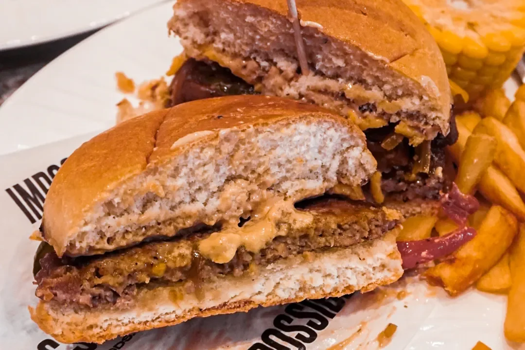 Impossible Burger cross-section on a bun with fries