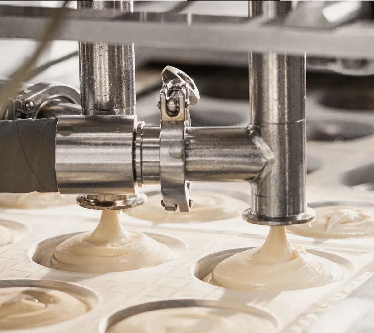 Miyoko's Creamery production line portioning fresh mozzarella into molds