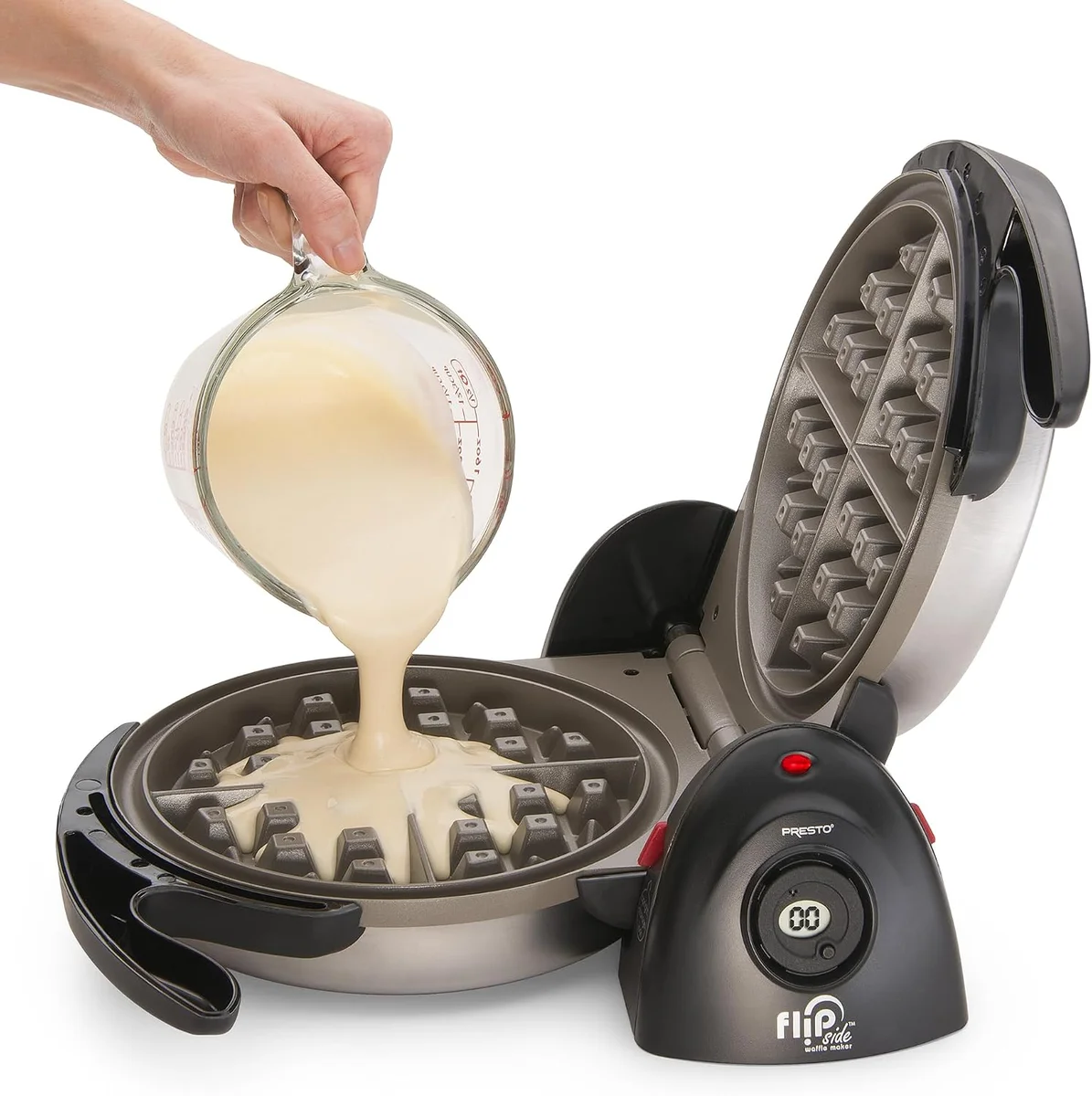 Batter being poured onto the open plate of the Presto FlipSide Belgian Waffle Maker before flipping